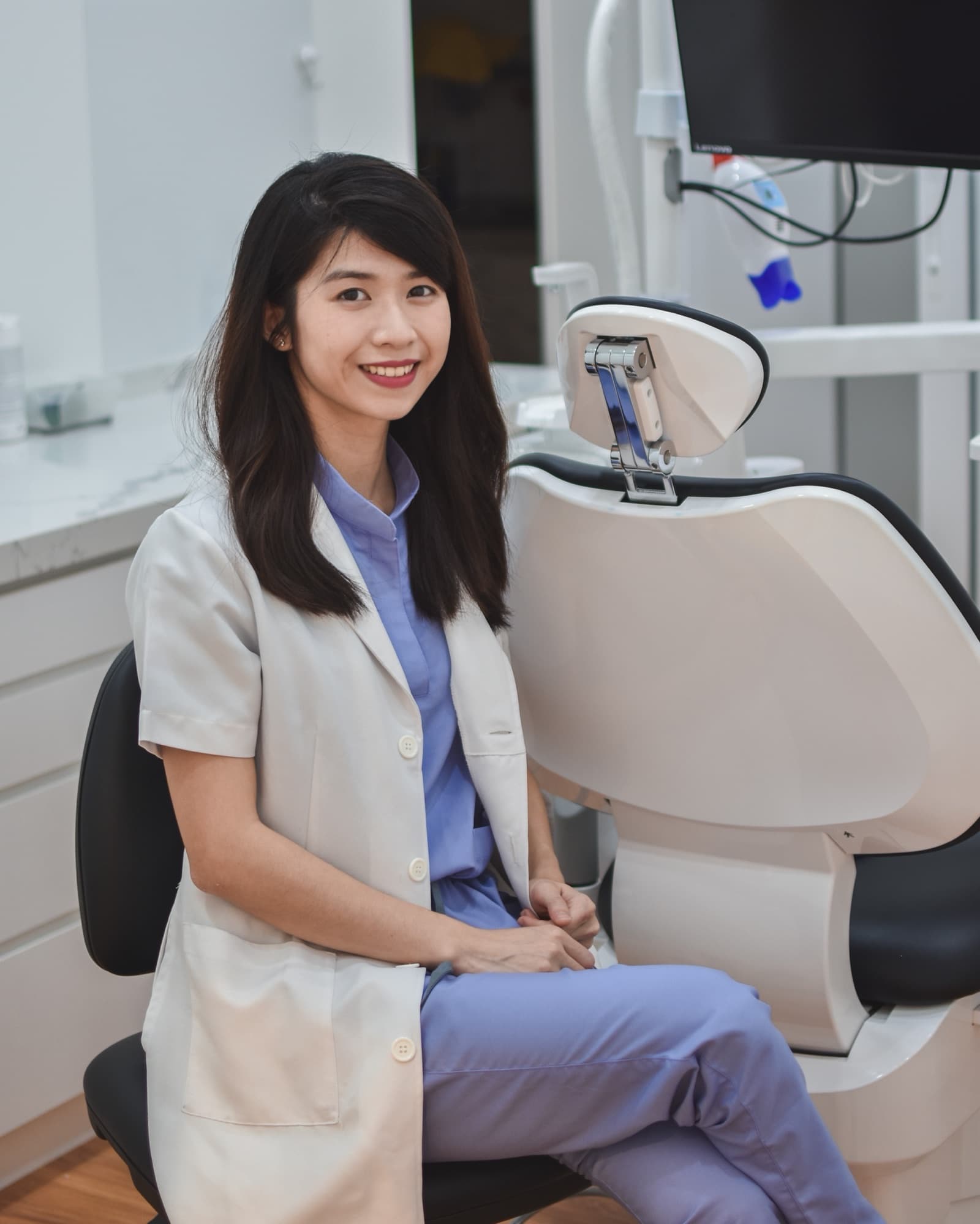 A dentist at Dental Valley Kajang beside the treatment chair